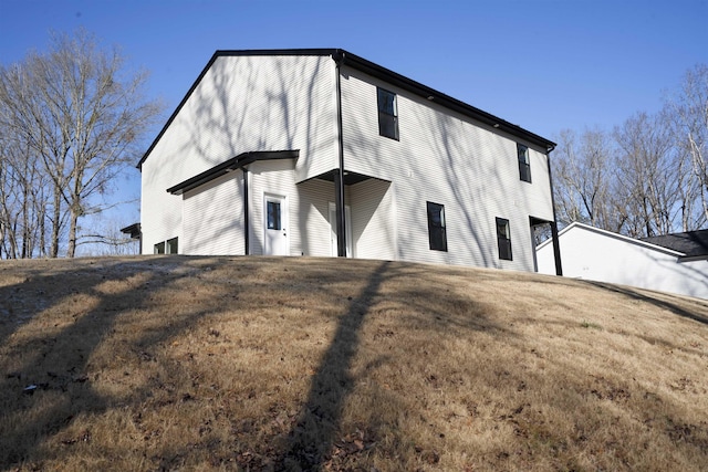 view of outbuilding featuring a lawn