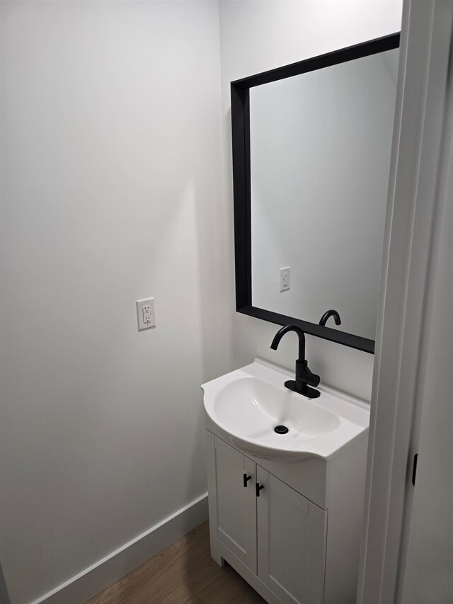 bathroom with vanity and wood-type flooring