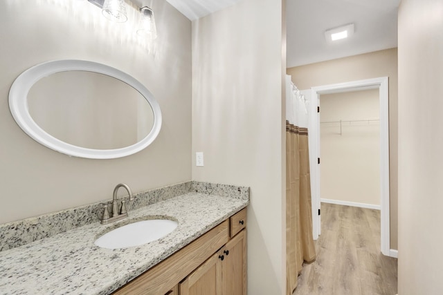 bathroom featuring vanity and hardwood / wood-style floors