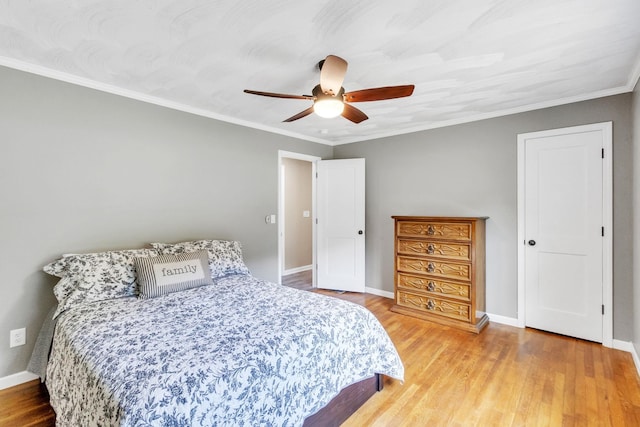 bedroom with crown molding, ceiling fan, and wood-type flooring