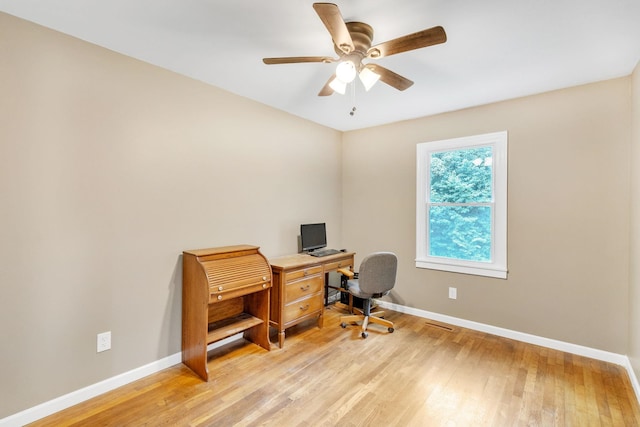 office with light hardwood / wood-style floors and ceiling fan