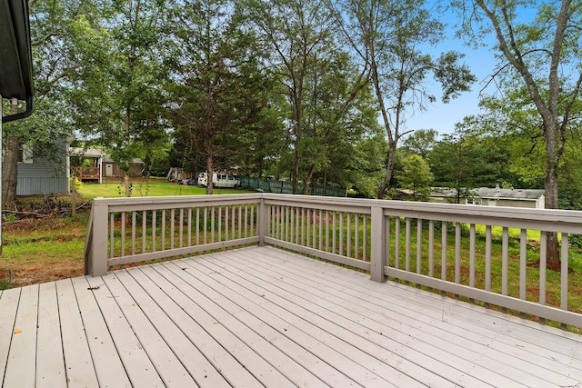 wooden terrace with a lawn