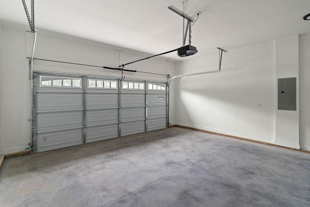 garage featuring a garage door opener, electric panel, and baseboards