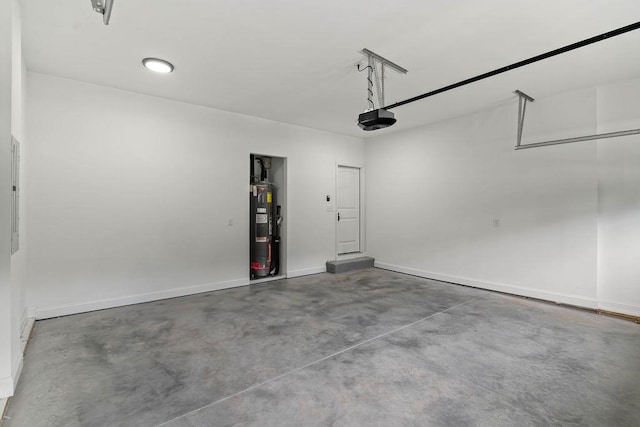 garage featuring a garage door opener, electric water heater, and baseboards