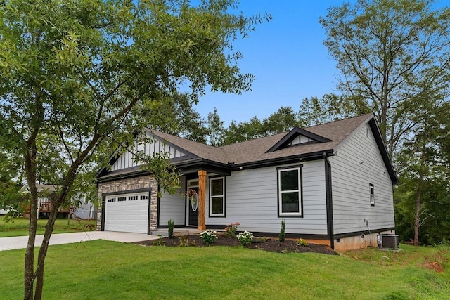 view of front of house with central AC unit, a garage, concrete driveway, roof with shingles, and a front yard