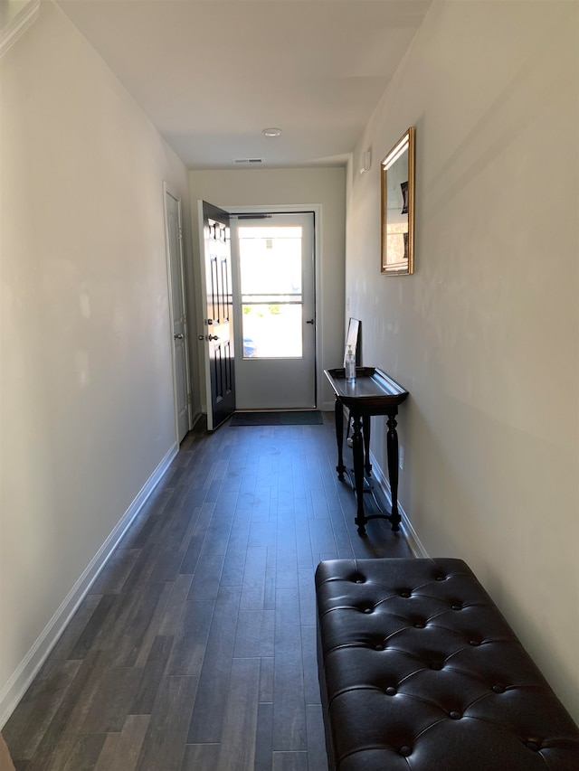 corridor with dark hardwood / wood-style flooring