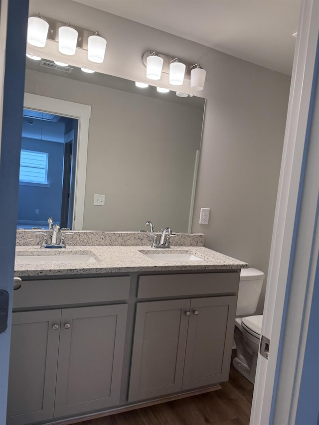 bathroom featuring hardwood / wood-style flooring, vanity, and toilet