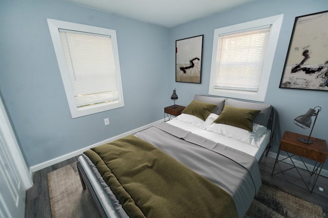 bedroom featuring hardwood / wood-style floors and multiple windows