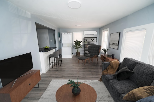 living room featuring light hardwood / wood-style flooring and a wall mounted AC