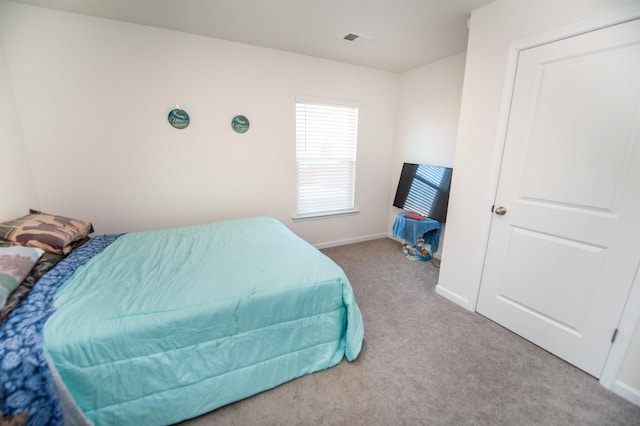 bedroom with light colored carpet