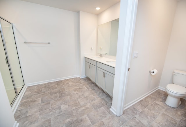 bathroom featuring vanity, toilet, and walk in shower