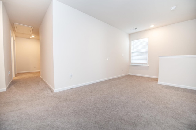 spare room featuring light carpet