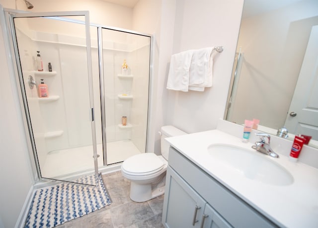 bathroom with walk in shower, vanity, and toilet