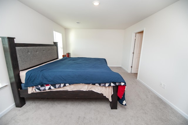 bedroom featuring light colored carpet