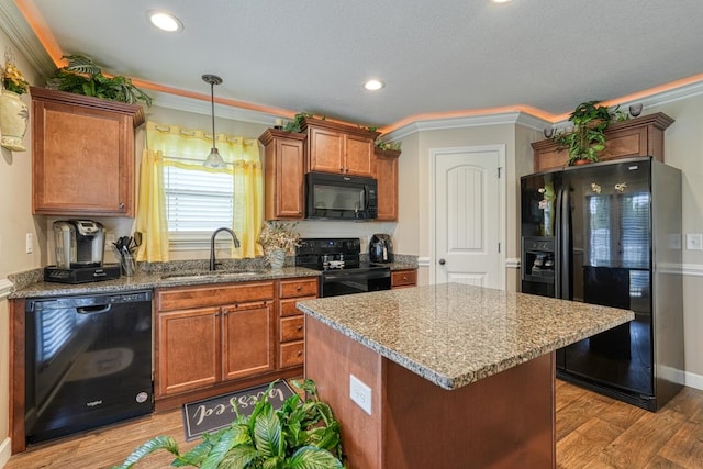 kitchen featuring ornamental molding, sink, black appliances, and light hardwood / wood-style floors