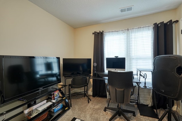 carpeted office featuring a textured ceiling