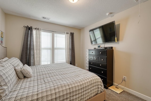 bedroom with a textured ceiling and carpet