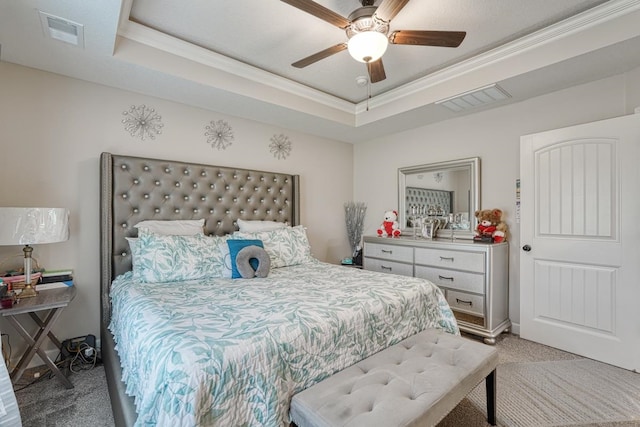 bedroom featuring ceiling fan, ornamental molding, light colored carpet, and a raised ceiling