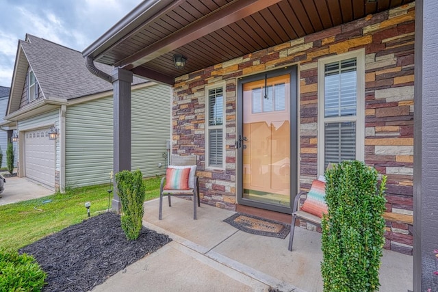 doorway to property featuring a garage and covered porch