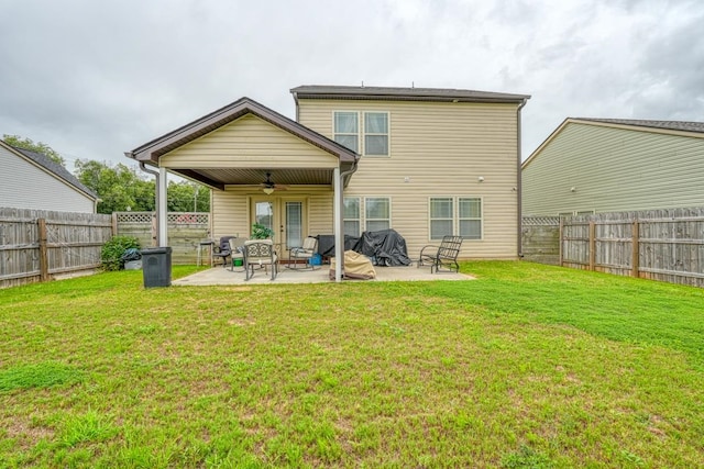 back of house with a lawn, a patio area, and ceiling fan