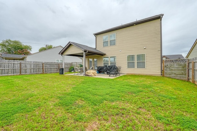 back of property featuring a lawn and a patio