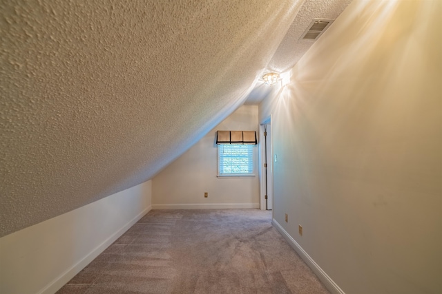 bonus room with vaulted ceiling, a textured ceiling, and carpet floors