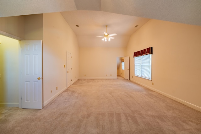 carpeted spare room with lofted ceiling and ceiling fan