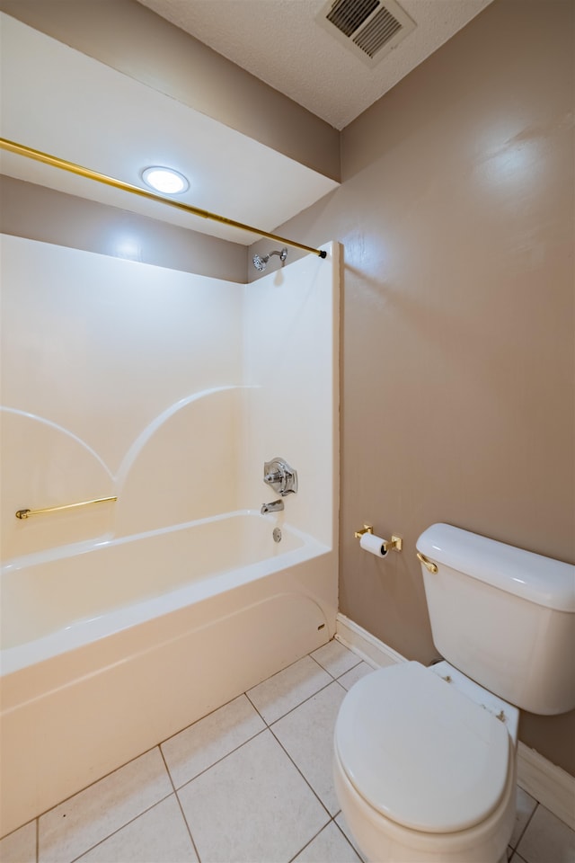 bathroom featuring tile patterned floors, toilet, and shower / washtub combination