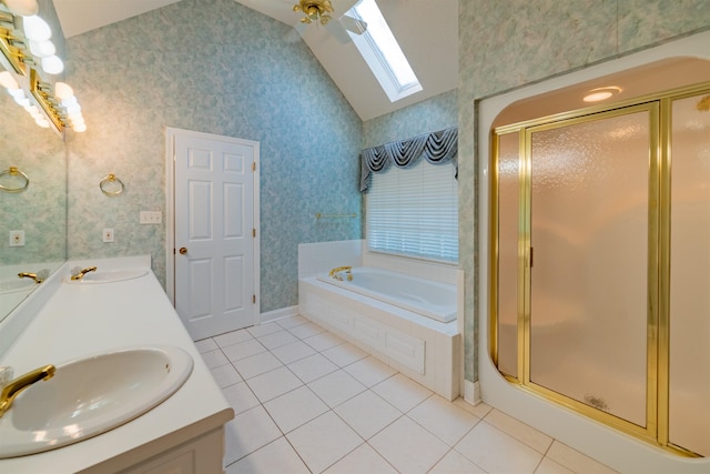 bathroom with vaulted ceiling with skylight, dual bowl vanity, separate shower and tub, ceiling fan, and tile patterned floors