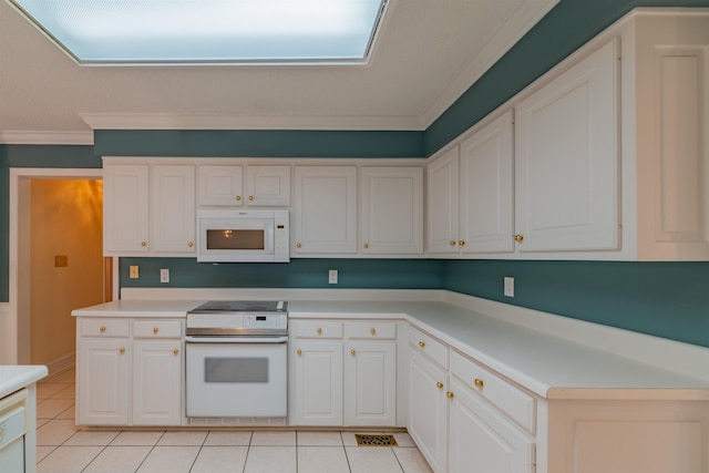 kitchen with light tile patterned floors, white cabinets, stove, and crown molding