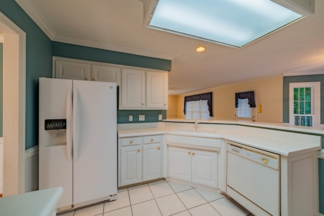 kitchen with light tile patterned floors, white appliances, sink, and white cabinetry