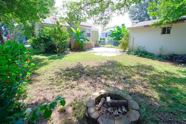 view of yard with an outdoor fire pit