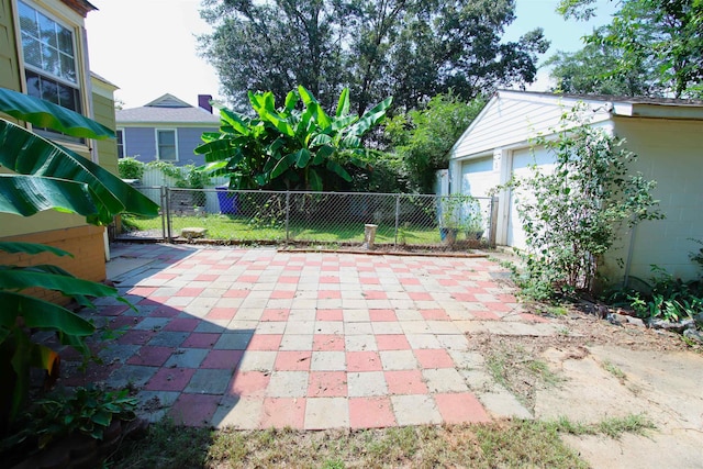 view of patio / terrace with an outbuilding and a garage