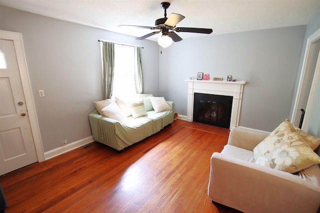 living room featuring hardwood / wood-style floors and ceiling fan