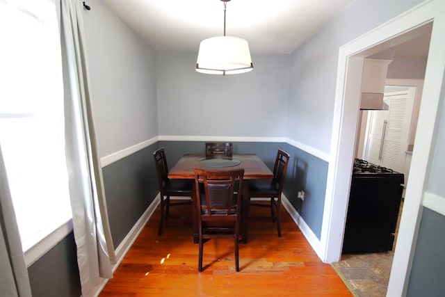 dining space with hardwood / wood-style floors