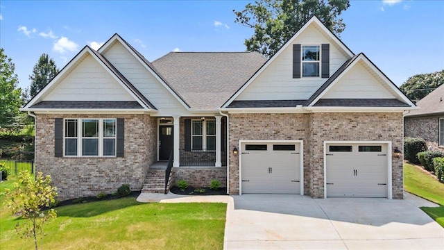 craftsman inspired home featuring a garage and a front yard