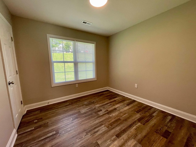 spare room featuring dark hardwood / wood-style flooring