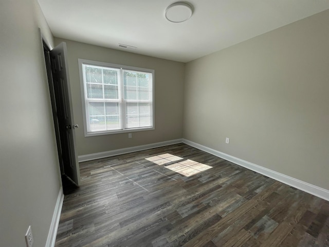 spare room with hardwood / wood-style floors