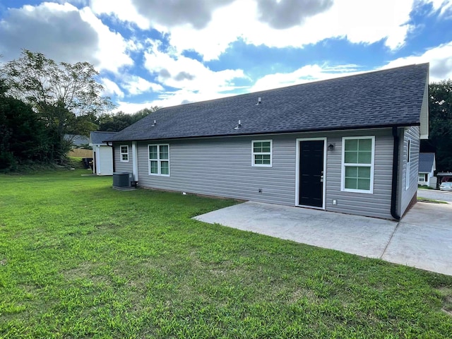 back of property with a patio area, central AC unit, and a lawn