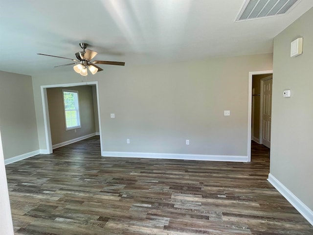 spare room featuring ceiling fan and dark hardwood / wood-style flooring