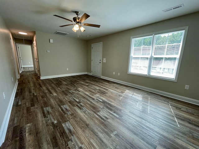 unfurnished room featuring ceiling fan and dark wood-type flooring