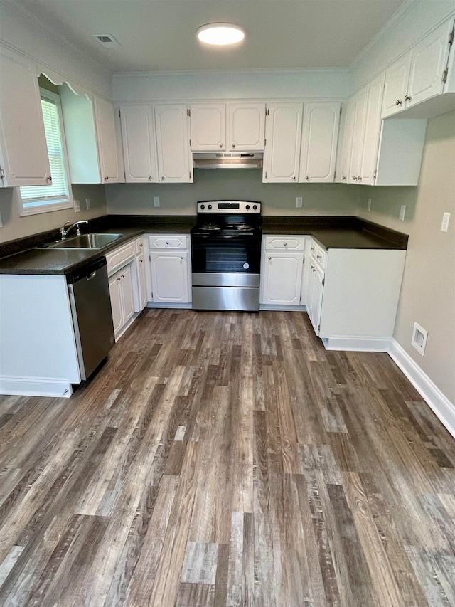 kitchen featuring stainless steel appliances, dark hardwood / wood-style flooring, and white cabinetry