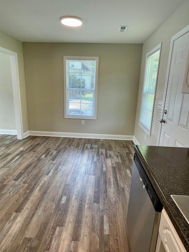 unfurnished dining area featuring dark hardwood / wood-style floors