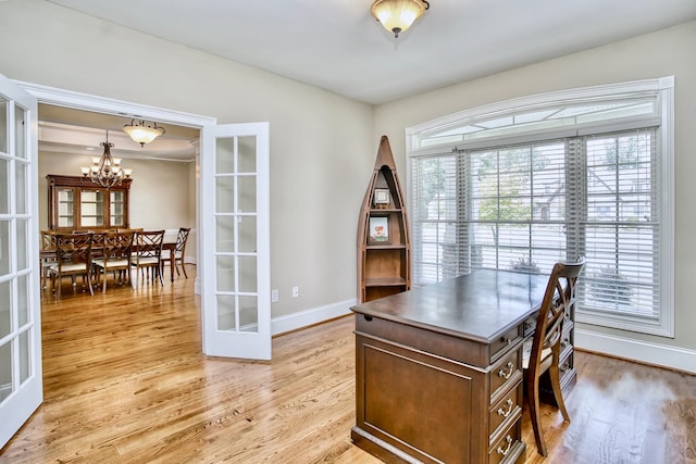 office featuring light wood-type flooring, french doors, and an inviting chandelier