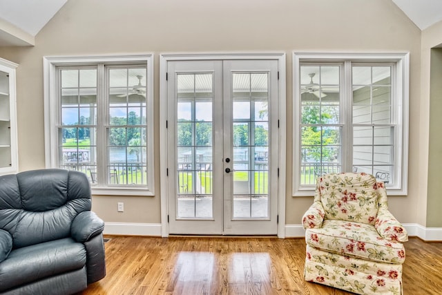 entryway with light hardwood / wood-style flooring, french doors, and lofted ceiling