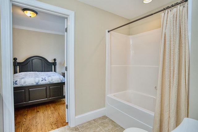 bathroom with shower / bath combo, ornamental molding, and hardwood / wood-style floors