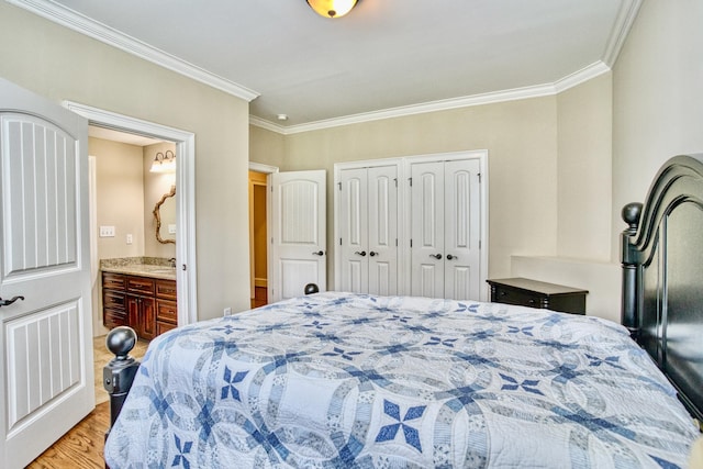 bedroom with connected bathroom, hardwood / wood-style flooring, and crown molding