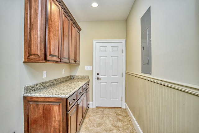 kitchen with light tile patterned floors and light stone countertops