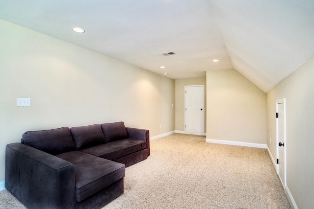 carpeted living room with vaulted ceiling