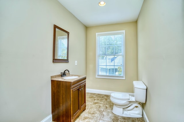 bathroom featuring toilet, tile patterned floors, and vanity